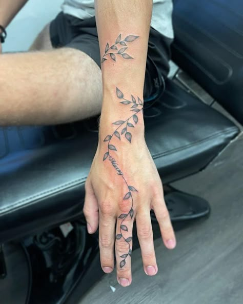 101 Best Vine Wrist Tattoo Ideas That Will Blow Your Mind! 15 Outsons Back Wrist Tattoo Men, Cool Vine Tattoos, Mens Vines Tattoo, Vine Hand And Finger Tattoo, Flower Tattoo Ideas Men, Vine Tattoos Neck, Vine Hand Tattoo Men, Minimalist Wrap Around Tattoo, Men’s Vine Tattoo