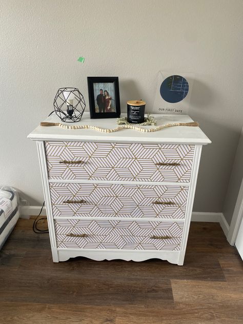 I took an old white dresser and turned it into this with only a few simple steps. 1. Simple white paint over top and sides. 2. Wallpaper over dresser drawers #wallpaper #dresser #diy #makeover Peel And Stick Wallpaper Dresser, Drawers Wallpaper, Wallpaper On Dresser, Dresser Diy Makeover, Wallpaper Dresser, Diy Upcycled Decor, Gold Geometric Wallpaper, Dresser Diy, Upcycled Decor