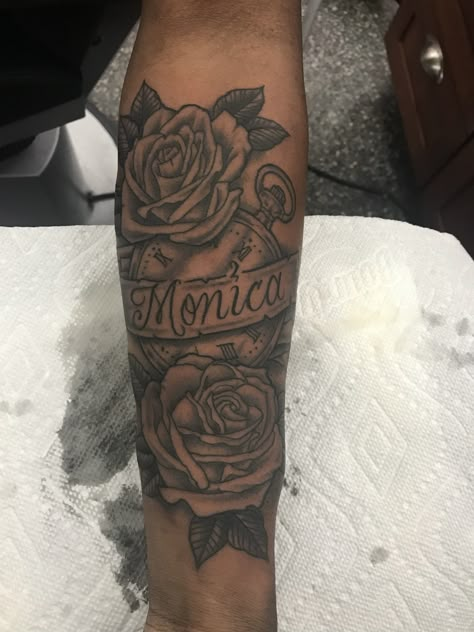 Rose Clock Ribbon Name tattoo for MOM Tattoo With Roses And Name, Name Half Sleeve Tattoo, Name Tattoo With Roses For Men, Name Tattoo With Roses Forearm, Forearm Tattoo Moms Name, Forearm Tattoo With Roses, Mom Name Tattoo Ideas Men, Mom Name Tattoo Designs, Mom Rose Tattoo For Men