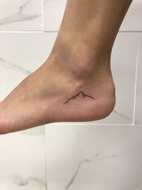 Tiny Mountain Tattoo Simple, Tiny Tattoo Mountain, Small Mountain Range Tattoo, Mountain Tattoo On Ankle, Mountain Heart Tattoo, Wv Mountain Tattoo, Foot Tattoo Placement Ideas, Simple Nature Tattoos For Women, Single Line Mountain Tattoo