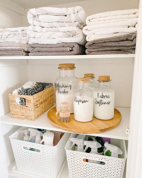 If you're lucky enough to have a separate closet for storing laundry supplies, this curated cabinet is for you. On the top shelf are folded towels, above a shelf dedicated to laundry detergent in small glass cork jars. Cleaning cabinets are a great way to keep supplies that shouldn't be displayed tucked away, and the shelf for towels is a bonus. Bathroom Organization Baskets, Detergent Storage Ideas, Diy Laundry Room Storage, Laundry Shelves, Storing Towels, Laundry Room Flooring, Laundry Design, House Organisation, Laundry Room Inspiration