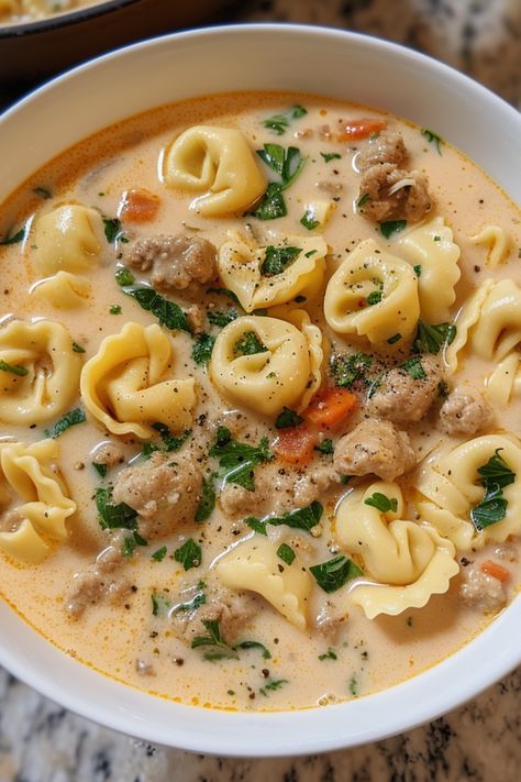 Enjoy the ultimate creamy sausage tortellini soup recipe, a deliciously easy and healthy meal with meat, vegetables, and dairy. Featuring Italian sausage for an authentic taste, it's the best way to warm up. You can prepare tortellini soup in a Crock Pot, instant pot, slow cooker, or stove top. Check out this tortellini soup recipe and more soup recipes at simplycalledfood.com. Ground Beef And Tortellini Soup, Sausage Tomato Tortellini Soup, Creamy Sausage Tortellini Soup Stovetop, One Pot Creamy Sausage Tortellini Soup, Tortellini Hamburger Soup, Turkey And Tortellini Soup, Cheeseburger Tortellini Soup, Tortellini Soup Easy Quick, Creamy Beef Tortellini Soup