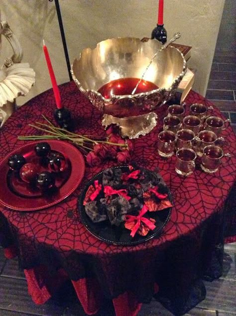 an elegant punch table with bloody punch and bloody apples, black and red candles Vampire Halloween Party, Punch Table, Vampire Victorian, Victorian Party, Vampire Party, Victorian Halloween, Vampire Masquerade, Halloween Tablescape, Halloween Party Dinner