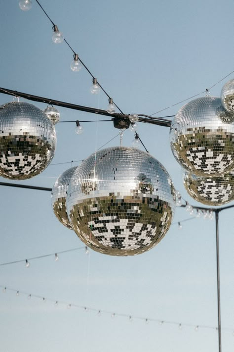 Wedding disco balls and lighting design by Luna Design Studios at Cavallo Ranch. Click on our website to get in contact with our team. URL: lunadesignstudios.com #wedding #weddingceremony #weddingideas #weddingfloral #californiawedding #ceremony #LDS #productiondesign #weddingdecor #eventdesigner #reception #floraldesign #tablenumbers #flowerarrangments #welcomesign #chandelier #menus #barsign #rentals #chairs #tables #lighitng #branding #signage #customsignage Wedding Disco Ball Dance Floors, Disco Ball Lighting, Disco Ball Wedding Dance Floor, Disco Ball Reception, Disco Ball Dance Floor, Disco Ball Outdoor, Disco Balls Wedding, Disco Ball Wedding Decor, Wedding Disco Ball