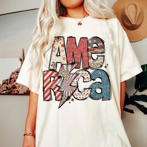 4th of July America White Shirt, Sparkly America Shirt, Independence Day T-shirt Cheap Trendy T-shirt For Independence Day, Cheap Printed T-shirt For 4th Of July, Cheap Fun Style Independence Day T-shirt, American Retro Cotton Tops For Spring, White Americana Letter Print T-shirt, White Americana Tops With American Flag Print, White Shirt With Flag Print For Spring, American Flag Print Shirt With Relaxed Fit For Spring, Multicolor Cotton Top For 4th Of July