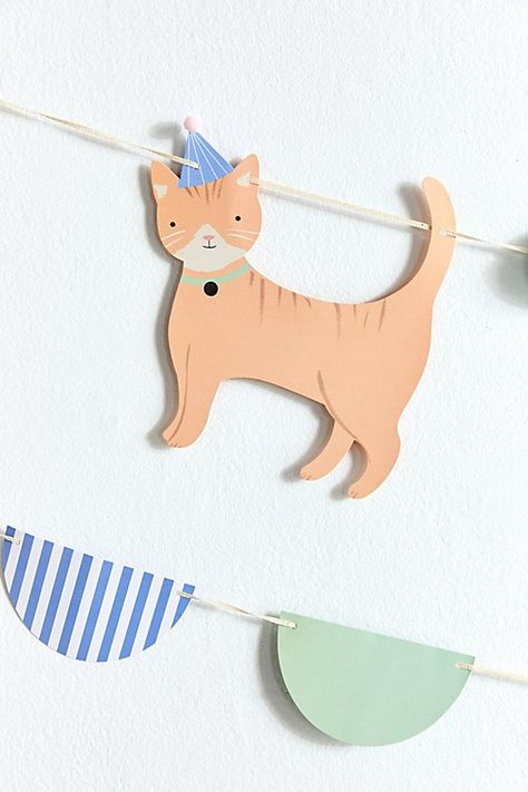 The purr-fect addition to your next celebration, Meri Meri’s Kitten Garland features itty bitty paper cats dressed to the nines in little party hats. Finished with a cotton cord for easy hanging. Features Meri Meri Kitten Garland Finished with kitten icons & pompoms Ready to display in your space with its integrated cotton cord Versatile - use it to celebrate your cat or yourself! Content + Care 90% Paper, 4% polyester pom poms, 4% polyester velvet ribbon, 2% cotton ribbon Wipe clean Imported Si Kitten Icons, Paper Cats, Meri Meri Party, Cat Themed Birthday Party, Party Cat, Kitten Party, Birthday Hats, Super Saturday, Cat Birthday Party