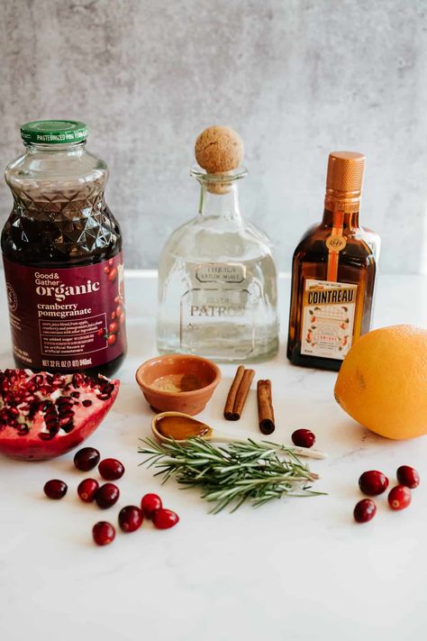 Delight in the holiday spirit with this Spiced Pomegranate Cranberry Margarita! A festive mix of pomegranate-cranberry juice, fresh orange juice, smooth tequila, orange liquor, & a hint of agave, spiced with cinnamon & ginger. Garnished with rosemary, cranberries, & pomegranate seeds, it's the perfect balance of sweet, tart, & cozy. Easy to make, stunningly seasonal, & can be adapted into a refreshing mocktail. A must-try cocktail for your holiday celebrations! #HolidayCocktail #MargaritaRecipe Cranberry Pomegranate Margarita, Pomegranate Rosemary Cocktail, Tequila Cranberry Cocktail, Pomegranate Cranberry Cocktail, Holiday Tequila Drinks, Cranberry Pomegranate Cocktail, Christmas Garnish, Sparkling Drinks Cocktails, Holiday Margaritas