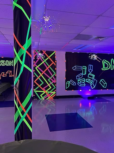 If you need neon party ideas, then you'll want to see this middle school dance decor! Throw a black and white party with glow in the dark tape, black school paper - it's an easy DIY party that glows in the dark! Glow In The Dark Theme Party Decoration, Glow In The Dark Hoco Ideas, Pole Decorations Ideas Party, Neon Nights Homecoming, Glow Party Ideas For School Dance, Neon Party Ideas Decoration Diy, Rave Theme Party Decorations, Glow In The Dark Tape Ideas, Glow Homecoming Theme