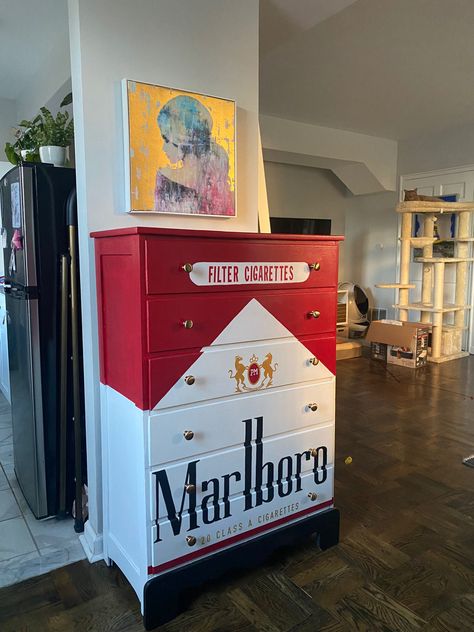 A dresser painted to look like a pack of Marlboro Red Cigarettes Aesthetic Shoe Storage Ideas, Cool Room Wallpaper, Spicy Room Decor, Weird Aesthetic Room, Fun Storage Ideas, Random House Decor, Bar Themed Room, Weird House Decor Diy, Unique Home Furniture