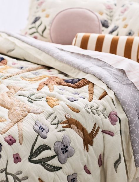 As charming as a fairytale, our Wonderland Prairie quilt features a whimsical forest scene overlaid with hand- and machine-embroidery for a textured, heirloom-quality look. Coordinating with a matching sheet set, the quilt reverses to a geometric floral pattern for maximum versatility. The lightweight organic cotton voile is perfect for warm nights or for layering on cooler ones for a happily-ever-after night's sleep.   • Shell: 100% organic cotton, grown without chemicals or pesticides  • Fill: Twin Bed Toddler Room, Fun Toddler Beds, Madeline Quilt, Flower Themed Nursery, Wildflower Bedroom, Vintage Kids Bedroom, Kids Quilts, Anthropology Bedroom, Wildflower Bedroom Kids Rooms