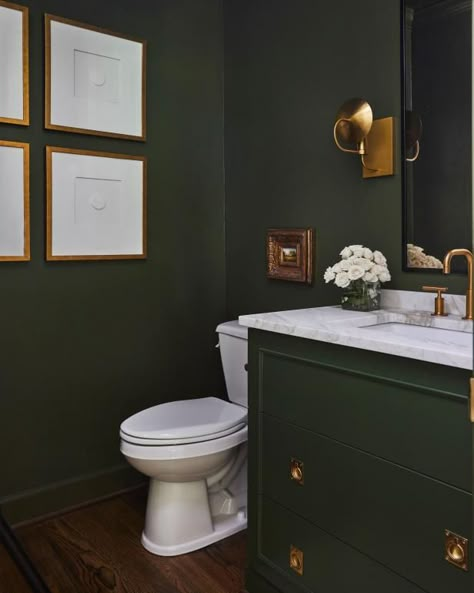 Transform your airy powder room into a moody jewel box with a few pails of paint and a couple of days to spare. This rich, olive-colored bathroom offers ample inspiration with deep green walls and vanity paired with creamy-white ivory accents and lustrous brass hardware. Achieve the same saturated look using similar paint hues like navy, chocolate, purple or oxblood and pair with metallic brass, gold or polished nickel hardware. Dresser To Vanity, Condo Aesthetic, Green Powder Room, Olive Green Bathrooms, Diy Bathroom Vanity Makeover, Transitional Powder Room, Casa Miami, Powder Room Refresh, Small Toilet Design