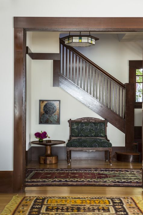 A vintage settee, antique rugs, a Blue Dot side table, and a custom chandelier lighten the mood in the house’s entry. Creamy White Walls, Reath Design, Craftsman Interior Design, Craftsman Home Interiors, Berkeley Homes, Alternative Seating, Dark Trim, Craftsman Interior, Bedroom Remodel