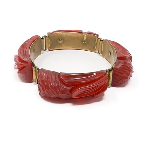 This stylish example of Bakelite jewellery dates from the 1930s.  Condition Report: Excellent The Details... This bracelet is constructed from gilded metal panels. Each panel is detailed with a cherry red Bakelite panel carved with a floral design. The bracelet fastens with a box clasp and measures 17cm in length.  A Short History... This bracelet is made from the thermoset plastic Bakelite used popularly in jewellery manufacture from the 1910s through to the 1940s. It has been proven to be Bake Bakelite Bracelets, Vintage Drop Earrings, Bakelite Jewelry, Liquid Silver, Daniel Fast, Metal Panels, Box Clasp, Plastic Jewelry, Vintage Bracelet