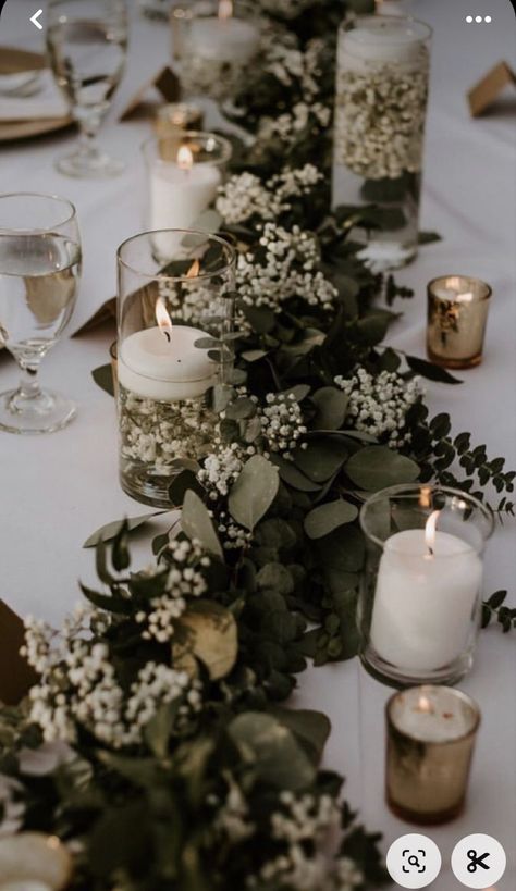 Candles And Greenery Centerpiece Long Table, Dark Green And Neutral Wedding, Floating Candles Wedding Centerpieces Reception Ideas, Olive Green Wedding Centerpieces, Babies Breath And Eucalyptus Centerpiece, Woodsy Wedding Table Decor, Eucalyptus Centerpiece Long Table, Succulent Table Arrangements, Wedding Foliage Decor