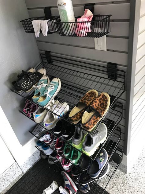 A mudroom, also known as an entryway where you can sit, take off your shoes and coat, can become an additional space in the garage just for you and your family. This is a relatively cost-effective way to vamp up your garage while also transforming it to be more functional. Bringing in a bench, a coat rack and some organizational slatwall baskets or shelves is all that is needed to create a mudroom suitable for easy storage and functionality. #mudroom #garagemudroom #homeorganization #garage Shoes Storage Garage, Wall Mounted Shoe Storage Garage, Garage Shoe Storage Wall Shelves, Slatwall Mudroom, Shoe Storage Garage Entry, Garage Shoe And Coat Storage, Garage Coat Rack Ideas, Shoe Organizer For Garage, Shoes In Garage Storage Ideas