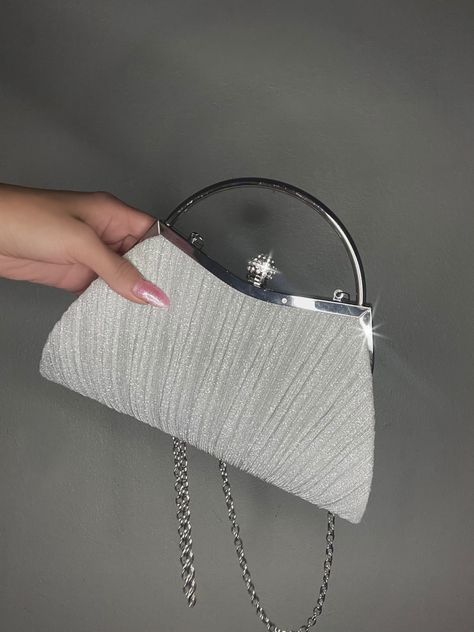 a hand holding a silver sparkly clutch with a metal short handle and long silver thin chain strap Silver Prom Purse, Prom Bags, 8th Grade Prom, White Clutch Purse, Comfy Jeans Outfit, Sparkly Clutch, Sparkly Purse, 20 Birthday, Prom Bag