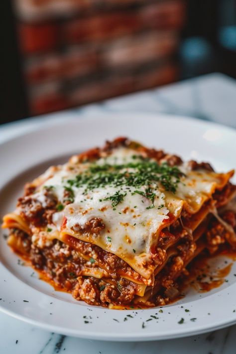 Indulge in a comforting homemade lasagna tonight with this delicious recipe! Layers of tender pasta, rich meat sauce, and creamy cheese make this classic dish an irresistible crowd-pleaser. Whether you're cooking for the family or hosting friends, lasagna is always a hit. Follow this simple recipe to create a mouthwatering lasagna that will have everyone asking for seconds. Enjoy the savory flavors and hearty goodness of lasagna - perfect for any occasion! Lasagna And Salad, Italian Dinner For Two, Simple Food Ideas For Lunch, Lasagna Photography Food Styling, Lasange Recipe Classic, Meaty Lasagna Recipe, Christmas Pasta Recipes, Dinner Recipes Friends, Lasange Recipe Homemade Lasagna