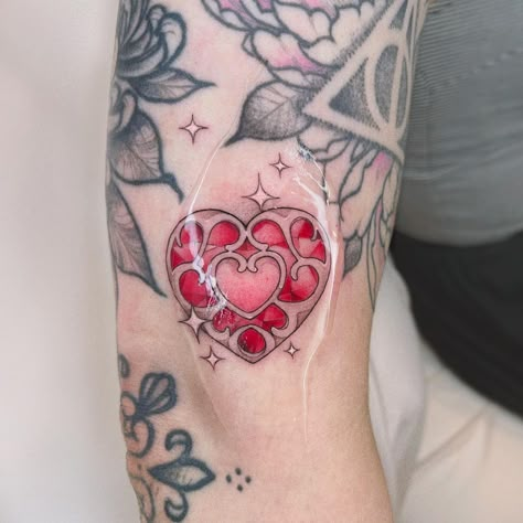 Part 2 of my art trade with @liesbethtatjana ! A lil heart container gapfiller 💖 Done at @leflux.tattoos ✿ follow the rest of the… | Instagram Legend Of Zelda Heart Container Tattoo, Heart Pieces Tattoo, 8 Bit Heart Tattoo, Stained Glass Heart Tattoo, Zelda Heart Container Tattoo, Matching Zelda Tattoos, Heart Container Tattoo, Princess Zelda Tattoo, Zelda Heart Tattoo