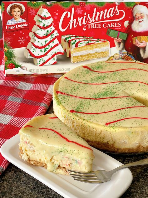 Indulge in the ultimate holiday dessert with the Little Debbie Christmas Tree Cake Cheesecake. A luscious Golden Oreo crust serves as the perfect foundation for this decadent delight. Nestled within is a layer of iconic Little Debbie Christmas Tree Cakes, adding a whimsical touch and nostalgic flavor. The creamy homemade cheesecake filling provides a velvety texture and rich taste that perfectly complements the cake layer. Little Debbie Cheesecake Christmas Tree, Little Debbie Christmas Cheesecake, Little Debbie Cheesecake, Christmas Tree Cake Cheesecake, Homemade Cheesecake Filling, Little Debbie Christmas Tree Cheesecake, Christmas Tree Cheesecake, Golden Oreo Crust, Little Debbie Christmas Tree Cakes