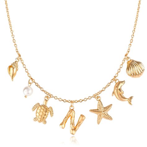 PRICES MAY VARY. ⭐【Boho Summer Style】 Embrace the essence of the beach with our Initial Charm Necklace for Women. This stunning gold chain necklace features an eclectic mix of charms including shells, dolphins, starfish, turtles, letters, pearls, and conch shells. Each charm is thoughtfully spaced to create a dynamic and playful design, perfect for capturing the carefree spirit of summer and adding a touch of boho-chic to your look. 🐚【Premium Materials】 Expertly crafted from high-quality alloy Seashell Letter, Conch Shells, Turtle Necklace, Gold Charm Necklace, Jewelry Fashion Trends, Pretty Necklaces, Letter Necklace, Boho Summer, Initial Charm