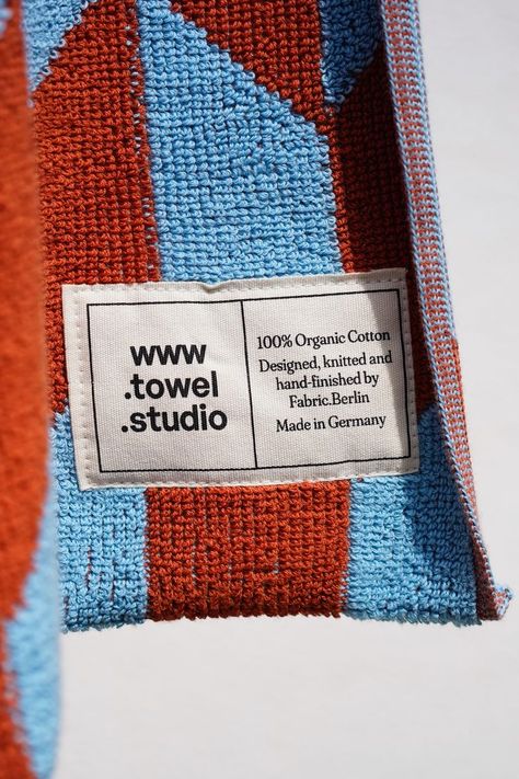 Towel Studio logo in black and white printed on a label and applied to a colorful cotton terrycloth towel. Blanket Design, Label Logo Design, Design Label, Rug Logo Design, Towel Packaging Design, Towel Branding, Towel Packaging, Textile Branding, Minimal Label Design