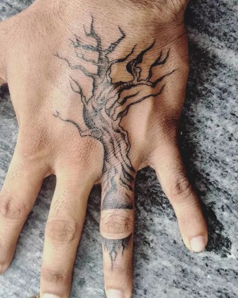 24 Tree Tattoo Ideas to Inspire Your Next Ink Design Poison Tree Hand Tattoo, Hand Tattoos Nature, Hand Tree Tattoo, Poison Tree Tattoo Meaning, Tree Tattoo Hand, Tattoo Filler Ideas Men, Tree Finger Tattoo, Nature Hand Tattoo, Traditional Tree Tattoo