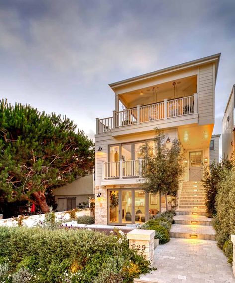 See this stunningly beautiful coastal style farmhouse in Manhattan Beach French Limestone Fireplace, Front Porch Lighting, Stone Facade, Exterior Paint Color, Beach Bungalows, Coastal Farmhouse, Manhattan Beach, House Paint Exterior, California Beach