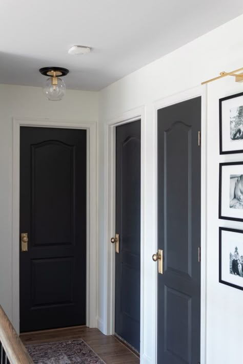 Hallway Decorating Black Doors, Hallway With Dark Doors, Blue Interior Doors Hallways, Small Hallway With Doors, Make Doors Look Expensive, Black Interior Doors Small House, Black Door Hallway Decor, Black Interior Doors Dark Floors, Hallway All One Color