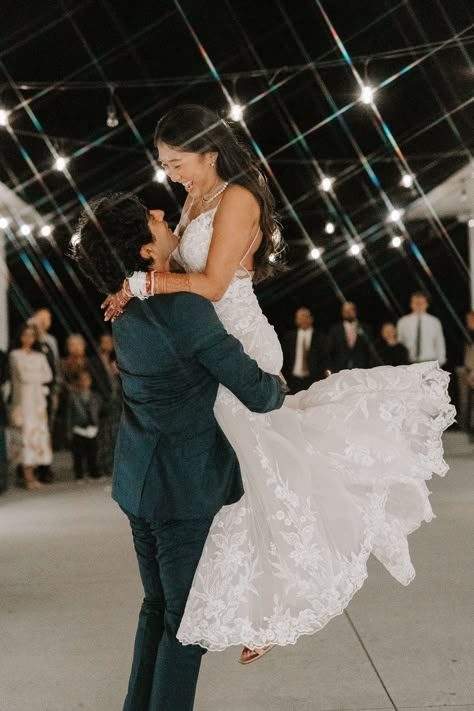 Bride and Groom Dance First Dance - With joy and affection, the groom sweeps his new bride up into his arms on the dance floor, lifting her off her feet and twirling her around as they sway and laugh together, cherishing their first dance as newlyweds at their magical wedding reception. Groom Spinning Bride, Bride And Groom Reception Photos, Bride And Groom First Dance Photos, Wedding First Dance Aesthetic, First Dance Photography, Wedding Reception Dancing Photos, Wedding First Dance Photos, First Dance Wedding Photos, Wedding Dance Photos