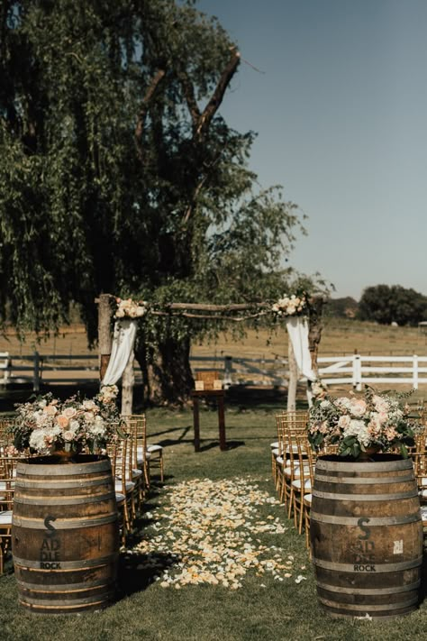 Outdoor Wedding Aisle Inspiration, Wine Barrel Ceremony Decor, Barrels At Wedding Ceremony, Wedding Arch With Barrels, Boho Ceremony Decor Aisle, Whiskey Barrel Wedding Decor Boho, Whisky Barrels Wedding, Beginning Of Aisle Arrangements, Wine Barrel Aisle Entrance