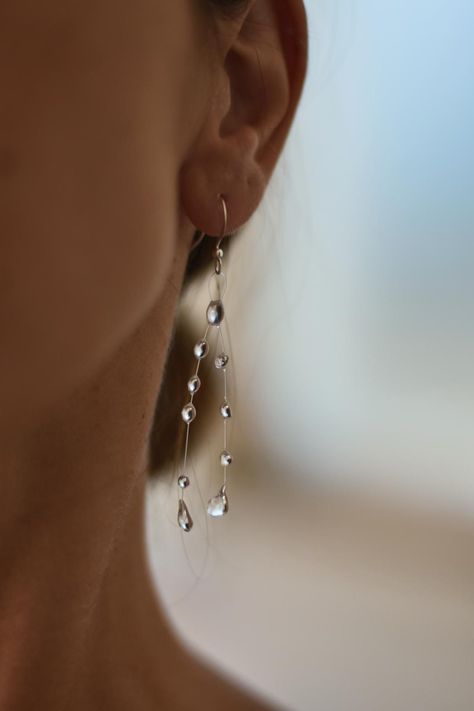 Water drop like earrings made of UV resin on monofilament line with stainless steel hooks.   Perfect for everyday wear or formal wear as they look like crystals. *Important* Keep in mind that every earring is made to order and there are no two same earrings. Every drop is unique and small changes are possible when it is handmade.  I always try my best to make it as similar as possible to the one you ordered.  Thank you! Water Droplet Earrings, Rain Drop Jewelry, Minimalist Dangle Earrings, Resin Drop Earrings, Water Drop Jewelry, Teardrop Beaded Earrings, Raindrop Jewelry, Queer Jewelry, Waterdrop Earrings