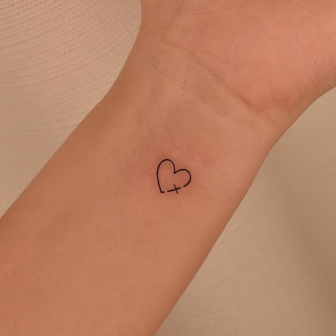 Cross Small Tattoo For Women, Minimalist Tattoo Faith, Small Wrist Tattoos For Women Christian, Cross Bicep Tattoo For Women, Tattoo Ideas Small Christian, God Heart Tattoo, Cross In Heart Tattoo, Tattoo Ideas Small Cross, Cute Small Tattoos Wrist