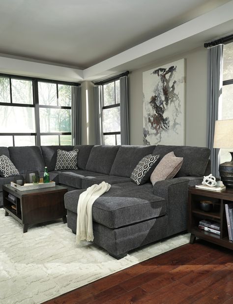 INFORMATION Talk about easy street. This effortlessly chic sectional puts you at the intersection of cool and comfortable. Ultra-deep seats are custom made for afternoon naps and movie night marathons. So plush to the touch, the sectional’s slate gray upholstery is beautifully on trend. Item Name: Tracling 3-Piece Sectional with Chaise by Ashley SKU: 72600S2 FEATURES Corner-blocked frame Attached back and loose seat cushions High-resiliency foam cushions wrapped in thick poly fiber 5 decorative Gray Sectional Living Room, Dark Grey Couch Living Room, Dark Grey Sectional, Dark Gray Sofa, Grey Sofa Living Room, Turkish Furniture, Grey Couch Living Room, Sectional With Chaise, Corner Chaise