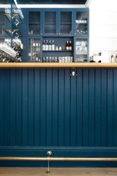 Dark blue bar at the Little London Plane in Seattle. Nautical Bar Design, Dark Blue Coffee Shop, Blue Cafe Aesthetic, Blue Coffee Bar, Blue Coffee Shop, Dark Blue Bar, Shiplap Bar, Blue Bakery, Cafe Bench