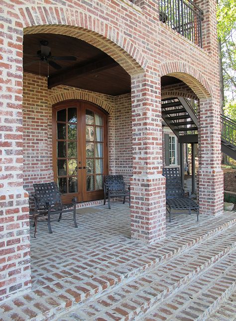 Arches and columns bring light and air into this backyard oasis. Brick stairs built with mortared pavers in a basket-weave pattern give the patio an extra touch of elegance. http://insistonbrick.com/ Exterior Brick House Colors, Brick Paint Colors, Brick Arches, Brick House Colors, House Columns, Brick Porch, Brick Companies, Brick Columns, Brick Arch