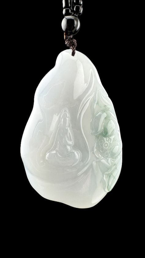 Grade A Burma Jadeite pendant featuring a serene Guanyin figure, symbolizing compassion, protection, and tranquility. The pendant is carved in an elegant, organic shape with smooth curves and a polished finish. Crafted from translucent light green jadeite, it exudes a calming and spiritual aura. The design includes subtle lotus flower carvings, representing purity and enlightenment. Paired with a black bead arrangement. White Jade Pendant, White Jade, Natural Jade, Jade Pendant, Spiritual Awakening, Inner Peace, Hand Carved, Jade, Carving