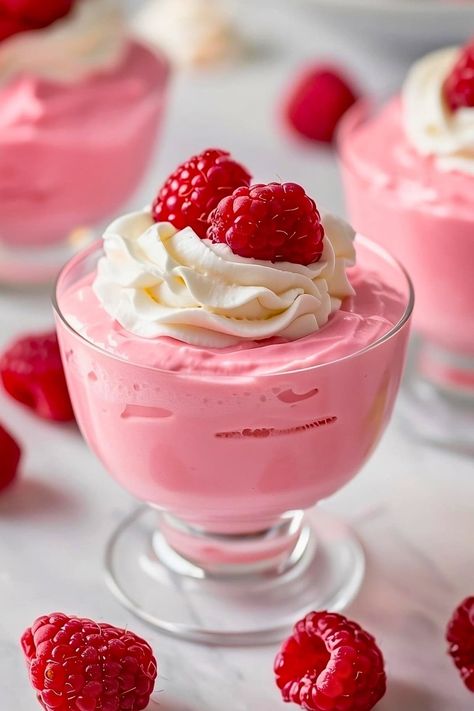 This traditional raspberry mousse recipe uses real raspberries for an intensely fruity flavor. It's pretty in pink, light, airy, and too good to miss. Pink Mousse Cups, Raspberry Mousse Pie, Raspberry Parfait Desserts, Easy Mouse Recipes, Raspberry Appetizers, Fruit Mousse Recipes, Raspberry Mousse Cake Filling, Dessert Recipes Raspberry, Mousse Dessert Recipes