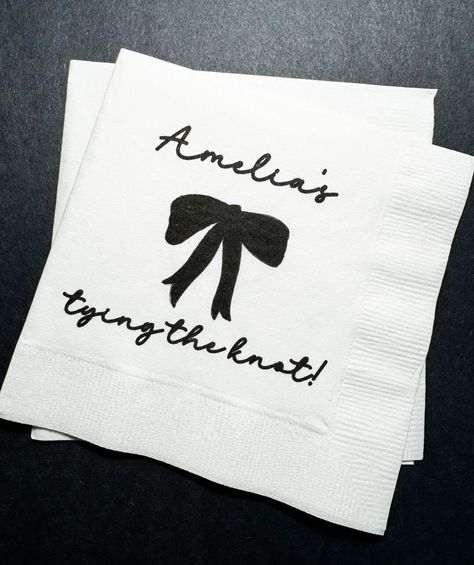 These adorable cocktail napkins are perfect for that She's Tying the Knot Black Bow bridal shower or bachelorette you are planning! These 3 ply cocktail napkins come in sets of 25, are approximately 5x5, and are printed with design and wording as shown. They are also available in luncheon or dinner size, which you can purchase by choosing this option in checkout, along with the quantity of sets you need. Please note these napkins come as shown, with personalization of one name, and there are no Black Bow Bridal Shower Theme, Bow Theme Bridal Shower Ideas, She's Tying The Knot Bridal Shower Theme, She’s Tying The Knot Bachelorette Party, Black Bow Party, Black Bachelorette, Shower Vibes, Shower Black, Chic Bridal Showers