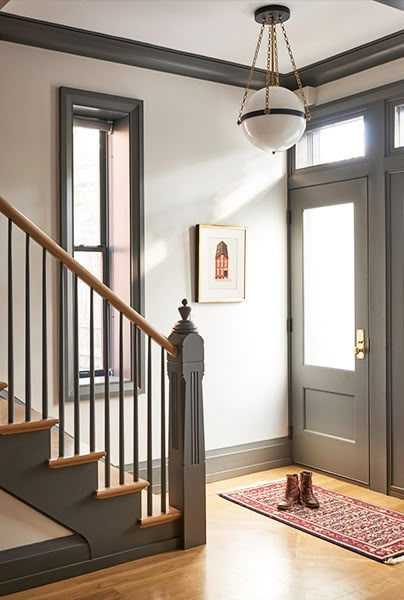 Painted Trim Ideas {That Aren't White} - The Honeycomb Home Charcoal Trim White Walls, Dark Color Trim Interior, Entryway Paint Ideas Foyers Wall Colors, Dark Baseboards And Trim, Dark Trim Interior, Darker Trim Lighter Walls, Dark Trim Light Walls, Light Walls Darker Trim, Chicago Townhouse