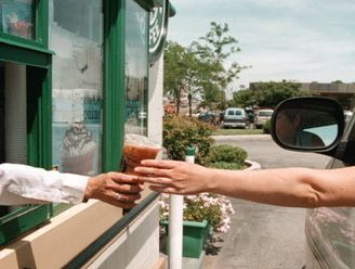 A driver reaches for her coffee order through a window at a drive-up Starbucks Coffee shop June 23, 2000 in Lombard, IL. Legislators in New Jersey want to pass a… Drive Through Coffee Shop, Coffee Drive Thru, Starbucks Drive Thru, Drive Thru Coffee, Distracted Driving, Pray For America, Jitterbug, Architecture Collage, Coffee Photos