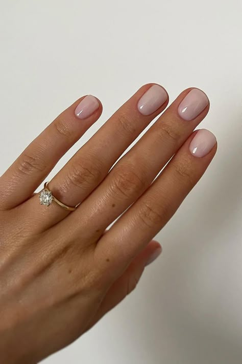 These elegantly shaped oval nails showcase a sheer pink hue that exudes a natural and refined look. The glossy finish adds a touch of sophistication, perfect for a timeless and graceful appearance. 🌸  // Photo Credit: Instagram @amyburvillnails Short Rounded Nails French Tip, January Nails Squoval, Natural Oval Nails Short, Bridal Nails Square Round, Nail Shape Squoval, Short Nails Shape Ideas, Short Bridesmaid Nails, Short Squoval Dip Nails, Short Rounded Oval Nails