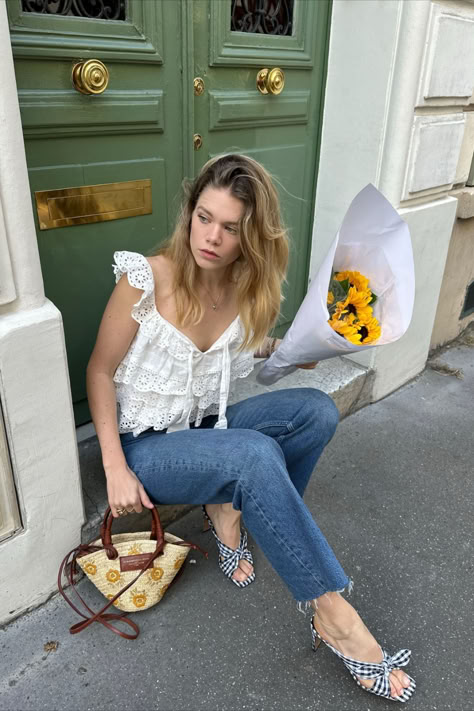 @elodieromy is wearing the Sézane Lia Blouse with the mini Justine basket bag with embroidered flowers. She styles her Sézane pieces with blue jeans and kitten heels for a perfect blend of casual and chic. Recreate this outfit now at sezane.com or via the app! Green Blouse Outfit, Light Green Cardigan, Light Green Blouse, Parisian Outfit, Chic Pants, Stylish Summer Outfits, Heels Outfits, Blue Striped Shirt, Green Cardigan