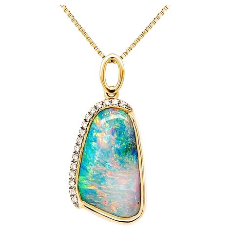 Extremely romantic and glamorous, ‘Madame Butterfly’ opal pendant features an attractive and versatile boulder opal (6.65ct) sourced from Winton mines in Queensland, Australia, bound to turn heads by its sheer beauty. Masterfully crafted in our gorgeous 18K yellow gold, the timelessly elegant boulder opal’s play-of-colour featuring subtle hues of pink, orange and blue is entirely magnificent. This pendant is a perfect addition to your jewellery collection or would make a graceful gift for that s Black Opal Jewelry, Metal Jewelry Making, Boulder Opal Ring, Madame Butterfly, Boulder Opal Pendant, Diamonds Necklace, Opal Pendant Necklace, Solid Gold Chains, Queensland Australia