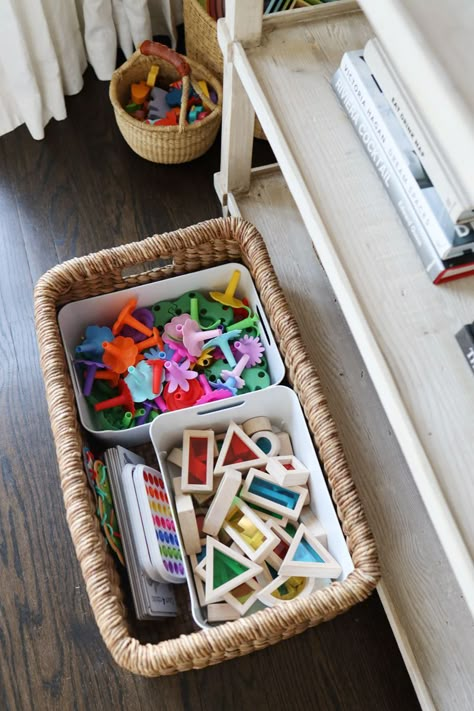 Our house has one living room that also functions as our family room. It was important to me that this room work for our whole family. That meant having a space that felt nice for adults, and one that had an area for my kids to play. Assuming that you don’t have a cabinet with closed doors, you’ll want to find storage that doesn’t look terrible. Lounge Toy Storage, Minimal Playroom, Small Toy Storage, Toy Basket Storage, Creative Playroom, Toddler Toy Storage, Playroom Organization Ideas, Toy Baskets, Kids Toy Organization