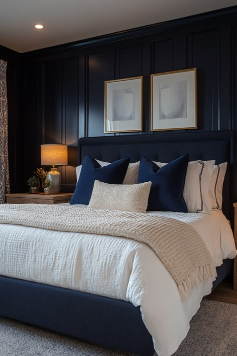 Create a cozy and chic navy blue and gold bedroom with these 29 stunning ideas.  Explore the versatility of this color combination to create a space that feels both inviting and luxurious.  Discover stunning decor ideas like navy velvet headboards, gold-framed mirrors, and brass light fixtures.  Add navy and gold throw pillows, gold geometric wall art, and plush navy carpets for a cozy and stylish bedroom oasis. Navy Spare Bedroom, Navy Wall Bedroom Decor, Midnight Blue Room Decor, Blue And Brass Bedroom, Navy Blue Wall Paneling Bedroom, Navy Bed Decor, Navy Bedframe Room Decor, Navy Blue Wall Bedroom Ideas, Bedroom Navy Headboard