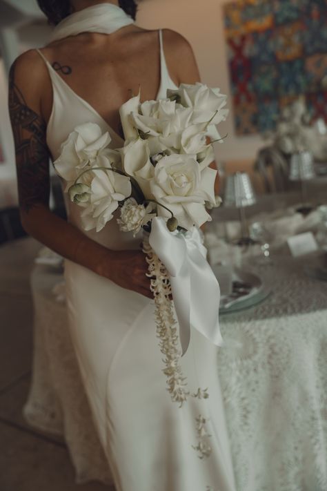 Elegant and minimal bridal bouquet featuring classic white roses, accented with a delicate ribbon and cascading florals. Perfect for brides embracing modern simplicity with a touch of romance. Cascading Floral Bouquet, Modern Cascade Bouquet, Bridal Bouquet Fall Cascading, Modern Bridal Bouquet Unique, Old Money Wedding Bouquet, Minimal Bridal Bouquet, White Cascade Bouquet, Minimalist Bridal Bouquet, Cascading Bouquet White