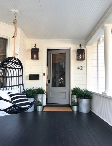 We painted our pink door gray! Come see what else we did for curb appeal. #mostlovelythings #graydoor #curbappeal #entryway #porch #hangingchair #planters #outdoorlighting #outdoorsconces Industrial Front Porch Ideas, Black Front Porch Floor, Black Porch Ideas, Craftsman Front Porch Ideas, Rustic Farmhouse Front Porches, Craftsman Front Porch, Black Porch, Farmhouse Front Porch Decorating, Modern Front Porches