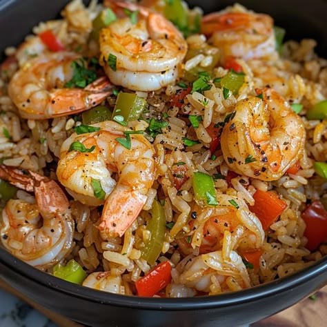 🍤 Shrimp Dirty Rice: A savory, spicy meal with a seafood twist! #SpicyShrimpRice Shrimp Dirty Rice Ingredients: Shrimp, peeled (1 lb (450 g)) Rice, cooked (2 cups (370 g)) Bell pepper, diced (1) Onion, diced (1) Celery, chopped (1/2 cup (60 g)) Cajun seasoning (1 tbsp (15 g)) Chicken broth (1/2 cup (120 ml)) Instructions: Sauté bell pepper, onion, and celery. Add shrimp and Cajun seasoning, cook until shrimp are pink. Stir in rice and chicken broth, heat through. 🌶️ Dive into the bold fla...