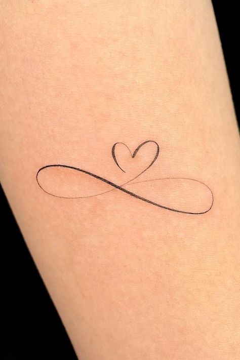 35 Stunning Small Heart Tattoo Ideas Heart Tattoo On Heart, Elegant Heart Tattoos, Red Infinity Tattoo, Forever Love Tattoo Symbols, Heart Dates Tattoo, Infinity And Heart Tattoo, Small Infinity Tattoos For Women, Everlasting Love Tattoo, Hart Tattoo Design