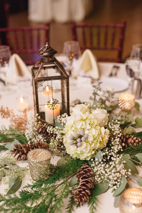 Katie warmed up her winter wedding decor with lanterns and candelabras on every table. The centerpieces also incorporated flowers from her bouquet, like hydrangeas, baby's breath, and pinecones. Pinecone Wedding Decorations, Winter Table Centerpieces, Christmas Wedding Centerpieces, Winter Table Decorations, Table Wedding Decorations, Winter Wedding Table, Winter Wedding Centerpieces, Xmas Wedding, Boda Diy